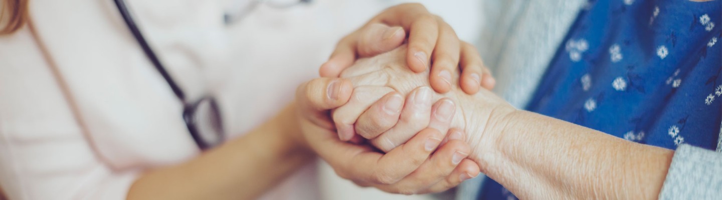 Medical provider holding hand of patient