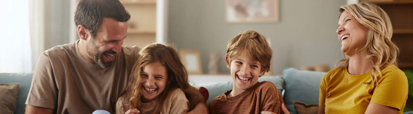 laughing family on couch