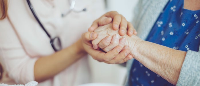 Medical provider holding the hand of a patient