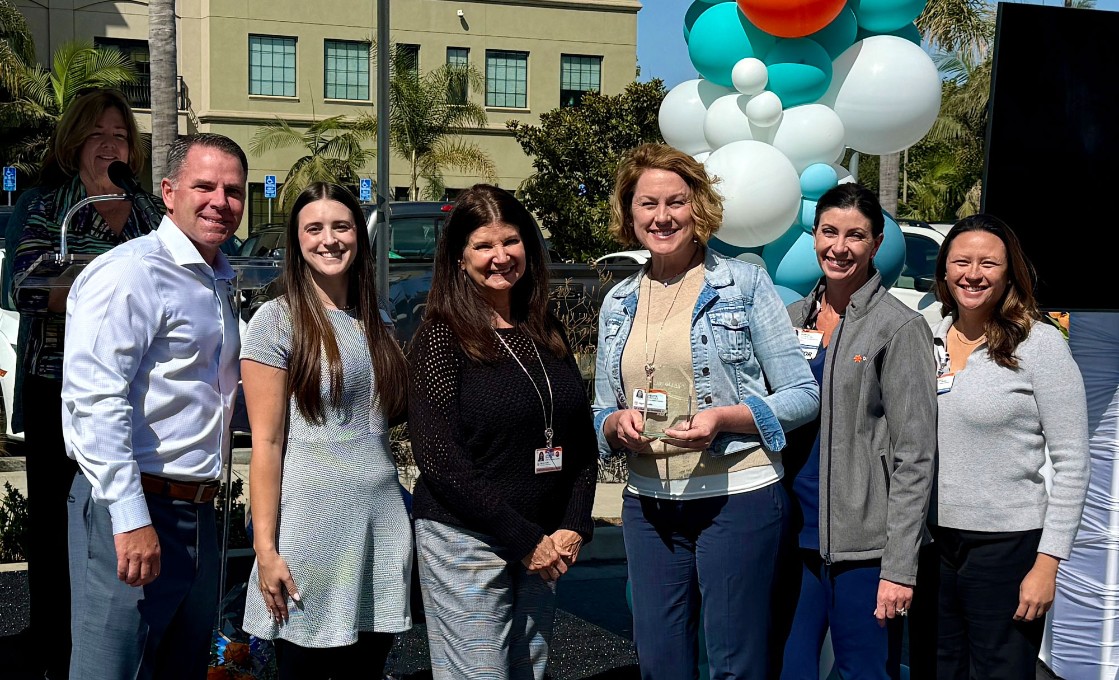 Team For the Pink Ribbon poses for a photo after being named the third-place team for Day of Hope fundraising, having raised over $20,000.