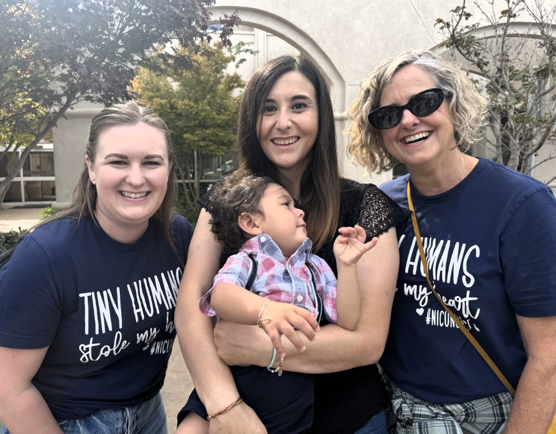 Jazmin Narez holds her son Armando while posing for a photo with staff members from Marian's NICU. 