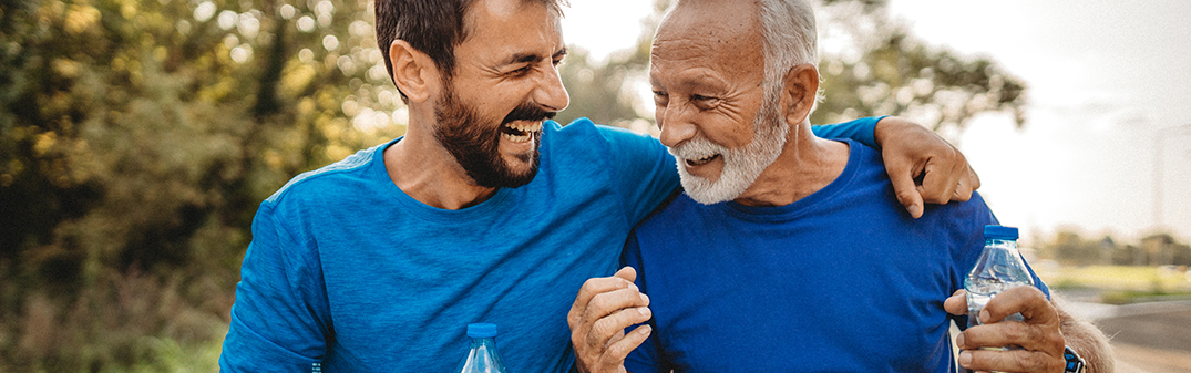 Man and father laughing together while working out