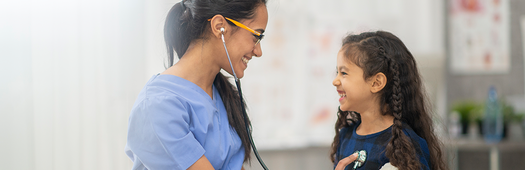 Female nurse checking a young girl patient