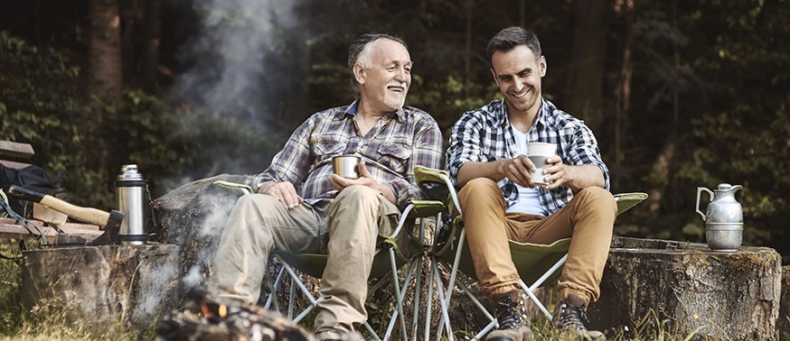 Men camping around a fire